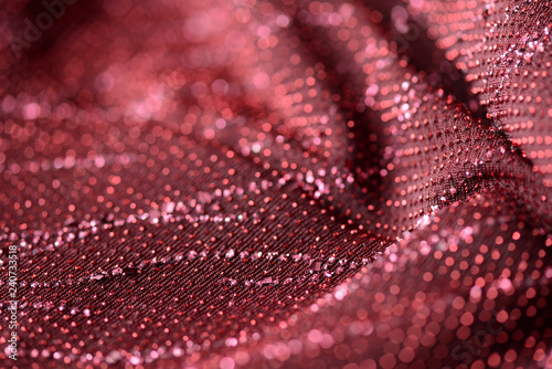 Red textile background with sparkles close up