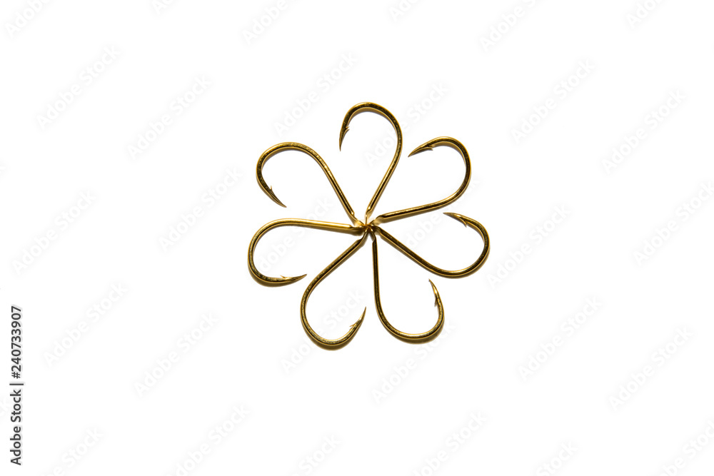 Fishing hooks in gold color. Different patterns of metal fishing hooks. Abstraction. Isolated.