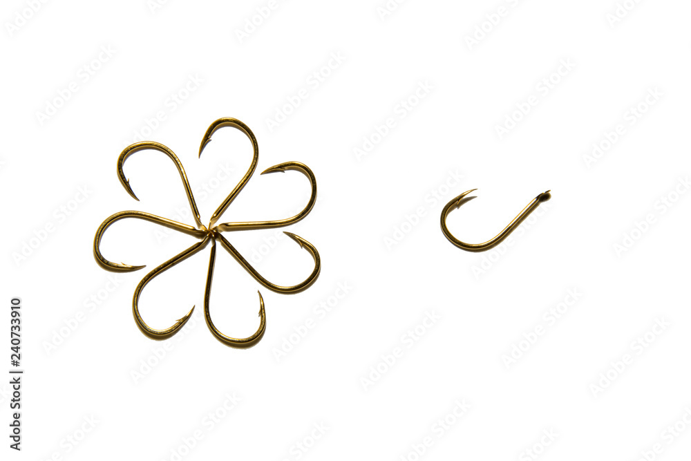 Fishing hooks in gold color. Different patterns of metal fishing hooks. Abstraction. Isolated. Fishing hooks in gold color. Different patterns of metal fishing hooks. Abstraction. Isolated.