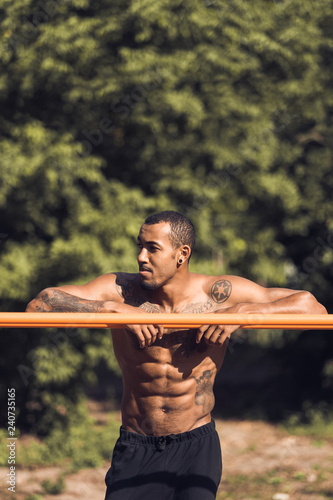 African-american muscular man taking break during morning workout