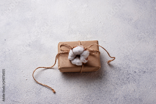 Gift box in craft paper deciration with cotton flower photo