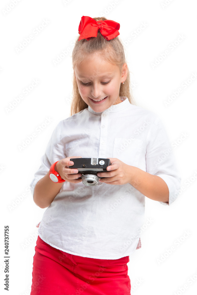 Full length portrait of cute little kid girl in stylish clothes looking at camera and smiling, standing against white studio wall with retro camera. Kids fashion concept Full length portrait of cute little kid girl in stylish clothes looking at camera and smiling, standing against white studio wall with retro camera. Kids fashion concept