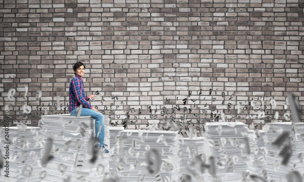 Attractive man sitting on pile of paper documents. Attractive man sitting on pile of paper documents.
