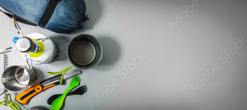 expedition camping equipment on gray background with copy space