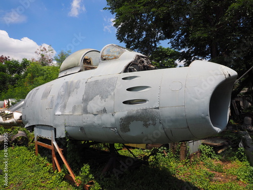Decaying military plane on rusty support