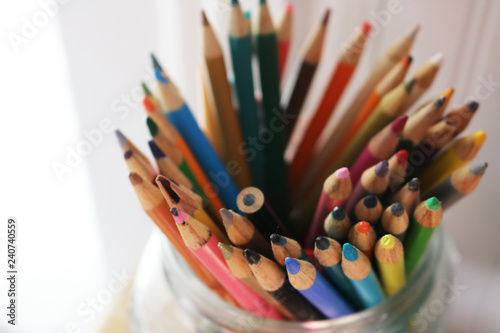 Isolated Jar of brightly colored pencils 