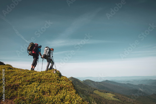 Travelers, friends relax on the mountain trail