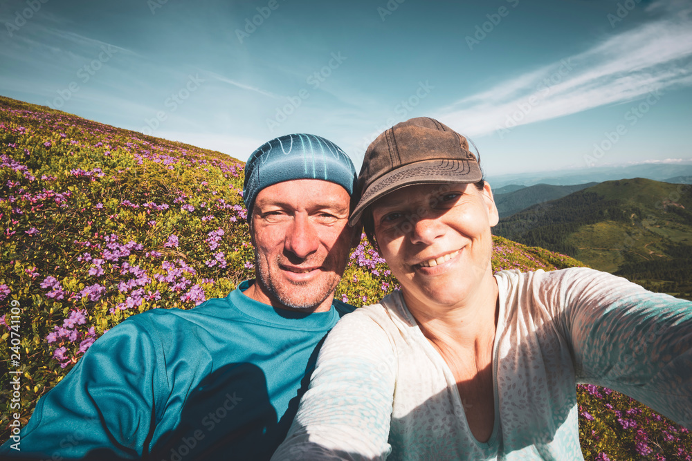 Travelers, friends taking selfie on the mountain trail Travelers, friends taking selfie on the mountain trail