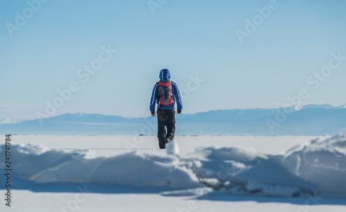 Man hiking on ice. Winter Landscape.