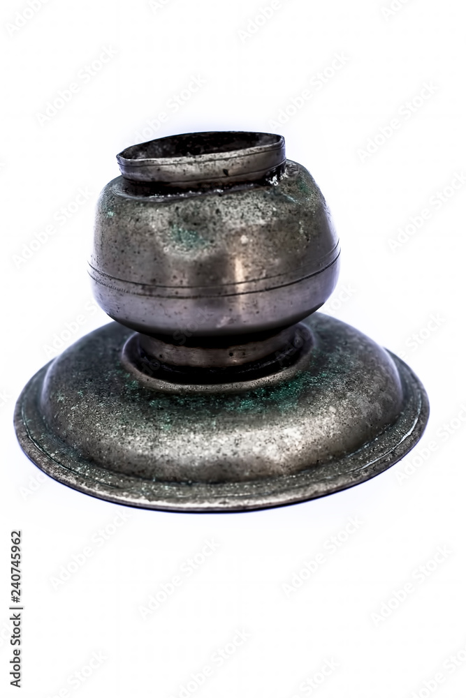 Close up of old ancient vessel or utensil or container or isolated on white i.e. Chilamchi or chelam or spit container or spittoon or brass spit container isolated on white. Close up of old ancient vessel or utensil or container or isolated on white i.e. Chilamchi or chelam or spit container or spittoon or brass spit container isolated on white.
