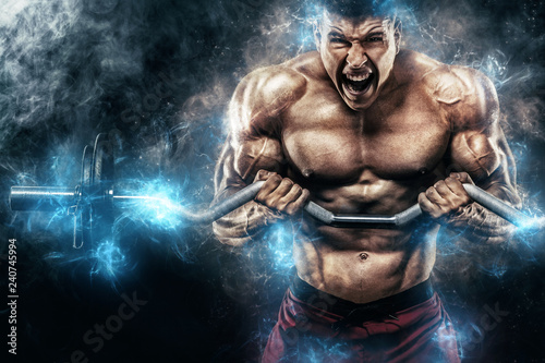 Obraz na plátně Brutal strong muscular bodybuilder athletic man pumping up muscles with barbell on black background