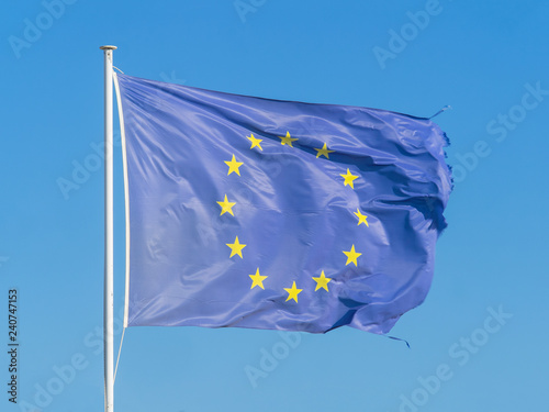 Frayed European Union (EU) flag is fluttered by wind