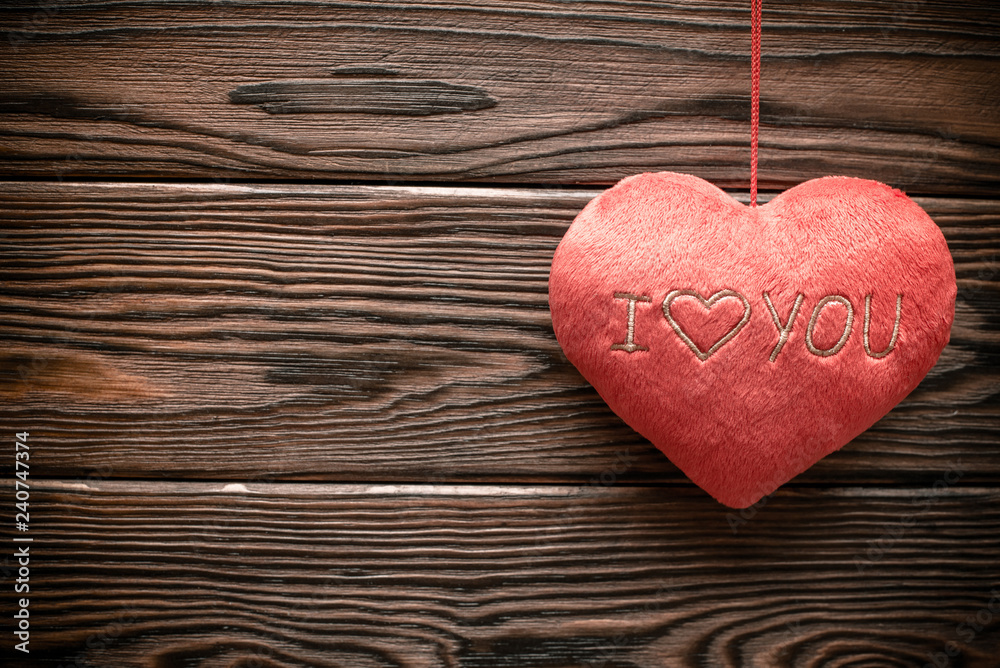 A symbol of love on brown wooden background A symbol of love on brown wooden background