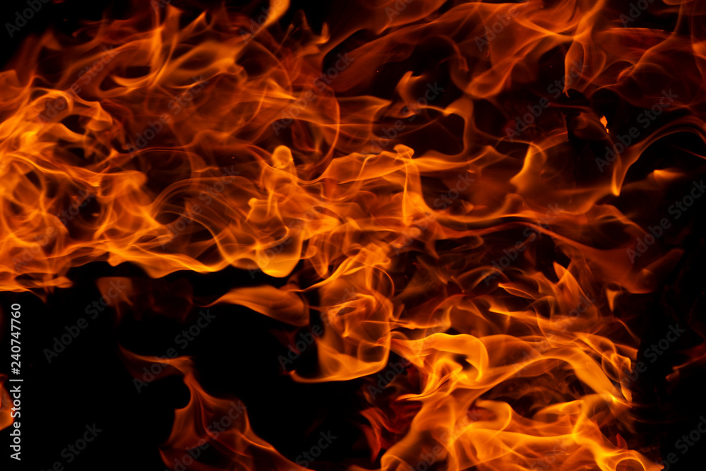 Fire flames on Abstract art black background, Burning red hot sparks rise from large, Fiery orange glowing Fire flames on Abstract art black background, Burning red hot sparks rise from large, Fiery orange glowing