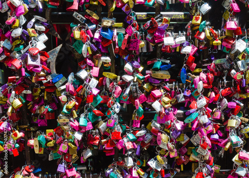Detail of the entrance door to the Giulietta house in Verona. Full of colorful padlocks left by lovers on the promise of respect for mutual love. Concept of loyalty in love.