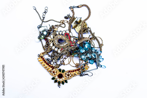 Close up of various jewelery objects isolated on white including necklace,bands,bangles etc.