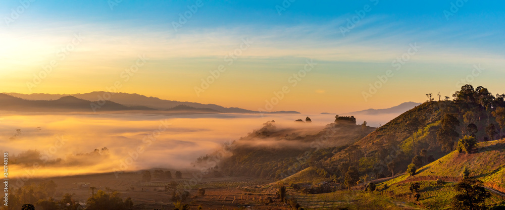 Mountain and foggy at morning time with orange sky, beautiful landscape in the thailand