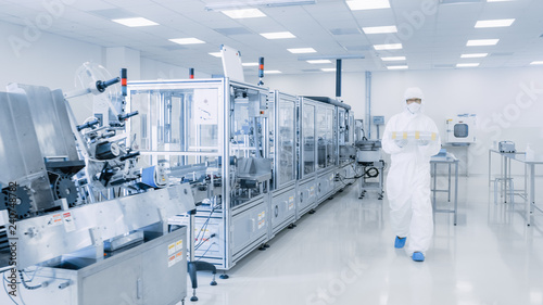 Shot of Sterile Pharmaceutical Manufacturing Laboratory where Scientists in Protective Coverall's Do Research, Quality Control and Work on the Discovery of new Medicine. 