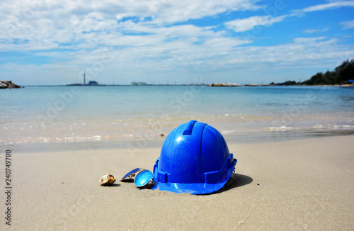 Safety Helmet and the sun glasses on the seascape background