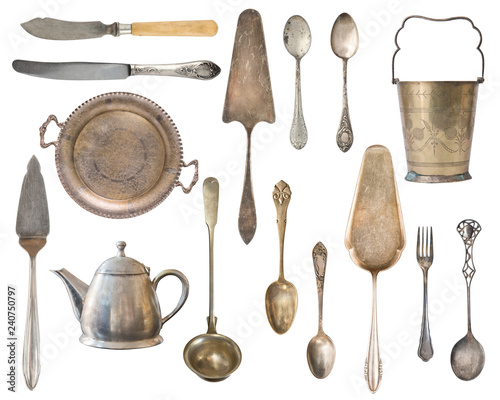 Vintage Silverware, antique spoons, forks, knives, ladle, cake shovels, kettle, tray and ice bucket isolated on isolated white background. Antique silverware. Retro.