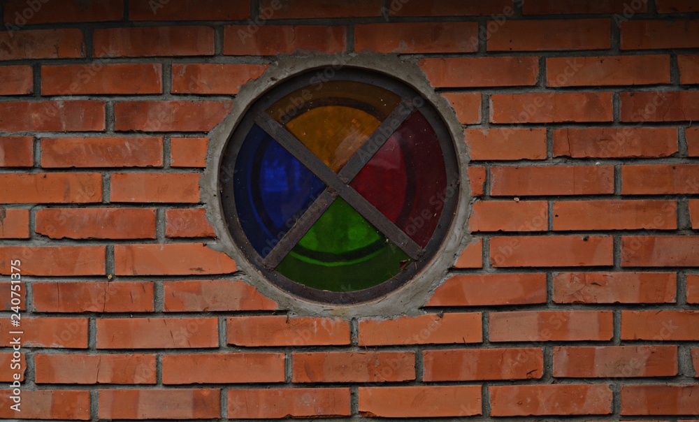 colorful window and the brick wall 