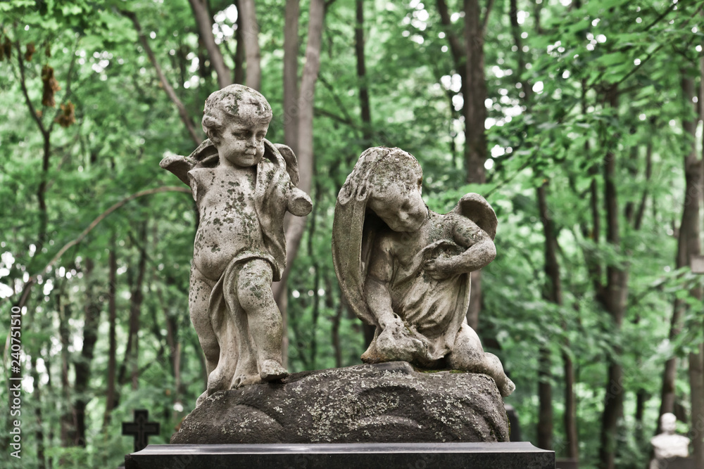 The Sorrowful Angel. Mourning cherubs on a background of foliage