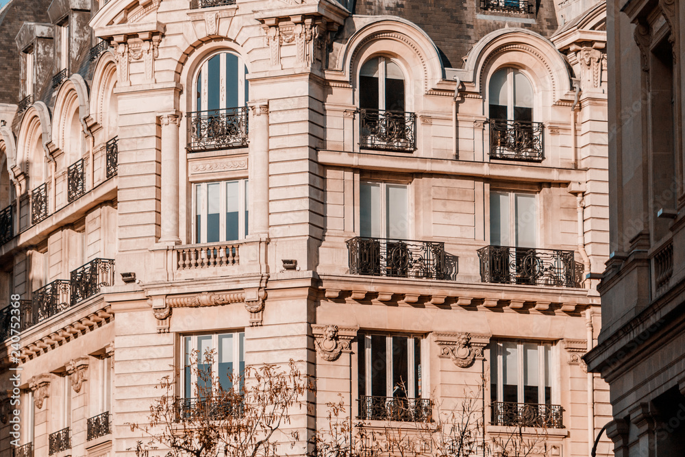 View from below on a facade European building with balconies in Paris, France. Neoclassicism  architecture style.