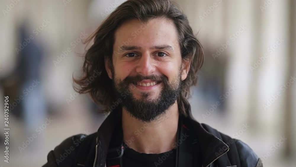 Close up shot of smiling bearded young man looking at camera. Close up shot of smiling bearded young man looking at camera.