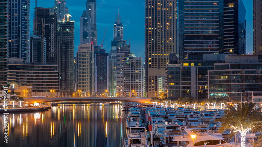 View of Dubai Marina Towers and canal in Dubai night to day timelapse