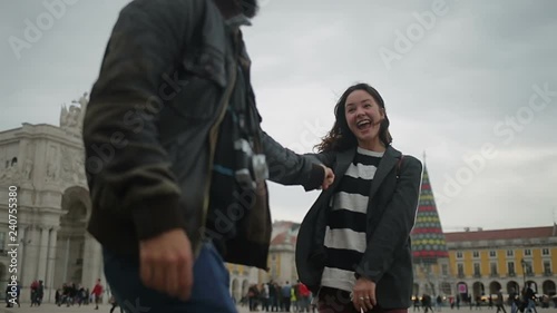 Happy young torists dancing on street. photo