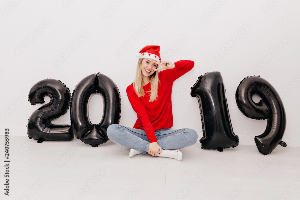 Happy exited girl with blond hair posing over isolated background with black numbers 2019 Happy exited girl with blond hair posing over isolated background with black numbers 2019