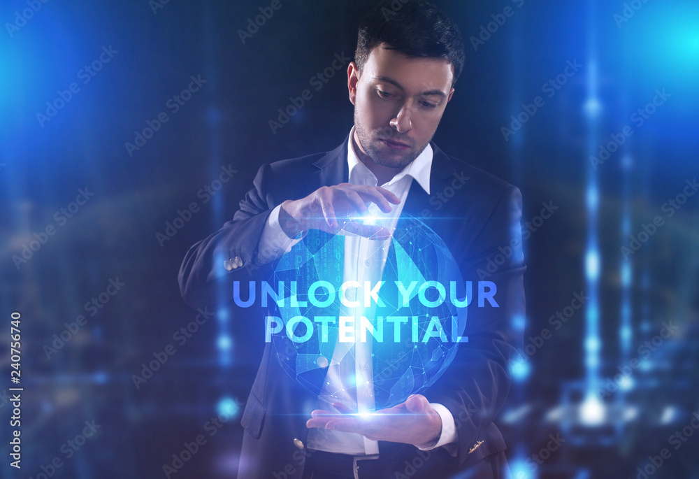 The concept of business, technology, the Internet and the network. A young entrepreneur working on a virtual screen of the future and sees the inscription: Unlock your potential The concept of business, technology, the Internet and the network. A young entrepreneur working on a virtual screen of the future and sees the inscription: Unlock your potential