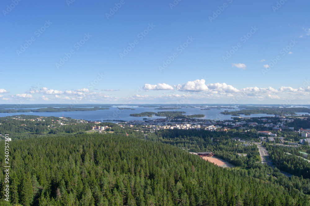Fototapeta premium Landscape of Kuopio from a tower in a sunny day at summer full of nature