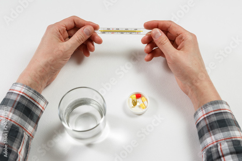 man hand with water on the background of pills