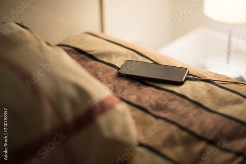 Smartphone is charging on bed, risk of explosion of poor battery quality