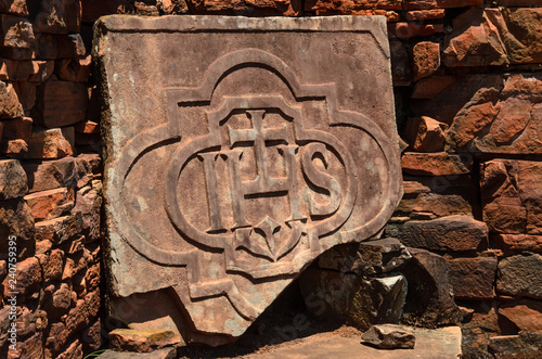 Piece of a stone pulpit graven or carved in stone with the Jesuits symbol in San Ignacio ruins, Misiones, Argentina