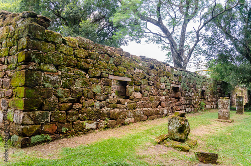 Old constructions covered with moss and full of windows and a corridor on the front in San Ignacio ruins, Misiones, Argentina