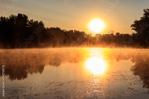 Fototapeta Naklejka Na Ścianę i Meble -  View of river in the mist at sunrise. Fog over river at morning