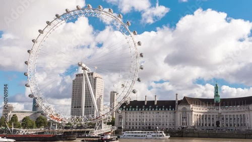 London, United Kingdom - Oct 18, 2016. 4K Timelapse of The London Eye observation wheel on River Thames bank in London, England. photo