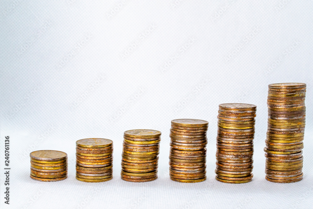 Columns of coins of the same value on a white background Columns of coins of the same value on a white background