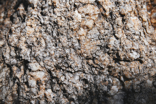 Close-up grungy rock textured with tiny glitter and shiny sharp pieces on the surface detail. Natural abstract background. © manees