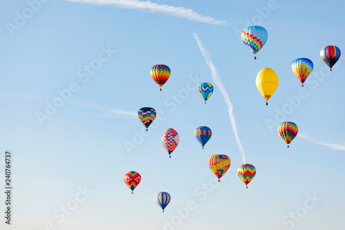 Multi colored hot air balloons flying over blue sky