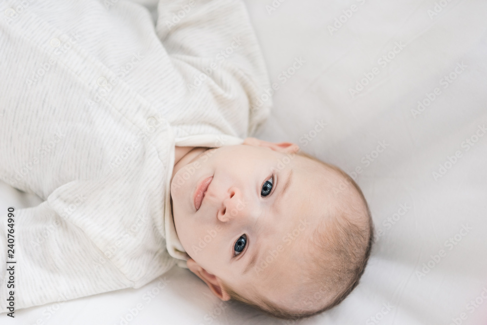 overhead view of adorable baby looking at camera overhead view of adorable baby looking at camera