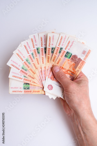Five thousand russian rubles in hand isolated on white background. Bundle of banknotes of 5000 rubles of the Russian Federation.