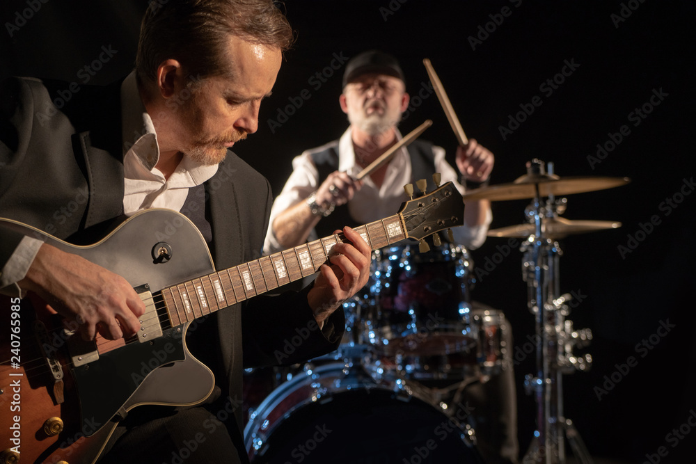 Fototapeta premium Guitarist and drummer play music