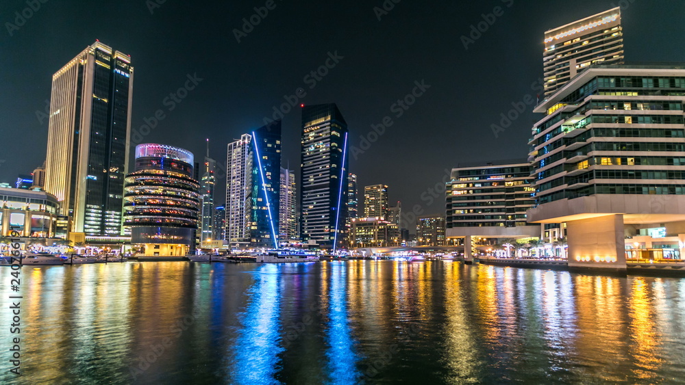 View of Dubai Marina Towers and canal in Dubai night timelapse