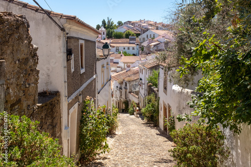 View down a narrow cobblestone street in the Jewish district of Castelo de Vide, Alentejo, Portugal