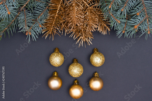 Creative decoration pattern with green and golden Christmas tree branches and baubles. Concept