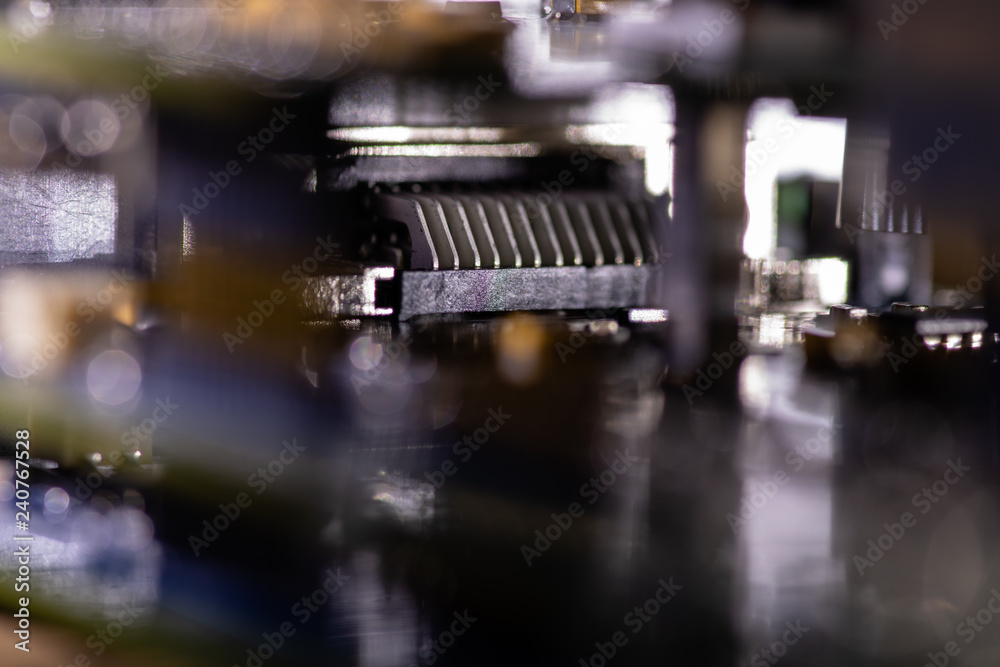 Close up (Macro) of Printed Circuit Board PCB embedded components (inductors, resistors, capacitors, diodes, microchips, transistor) with short depth of view.