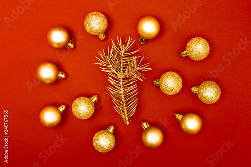 Multiple Christmas baubles creative decoration pattern with golden pine tree branch on the red background